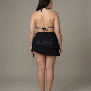 Woman in plus size swimwear, back view