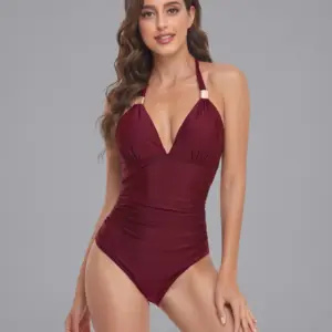 Mature woman in burgundy one-piece swimsuit